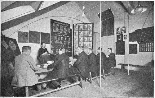 DETECTIVES RECEIVING A LESSON ON EARS.  From a Photo.