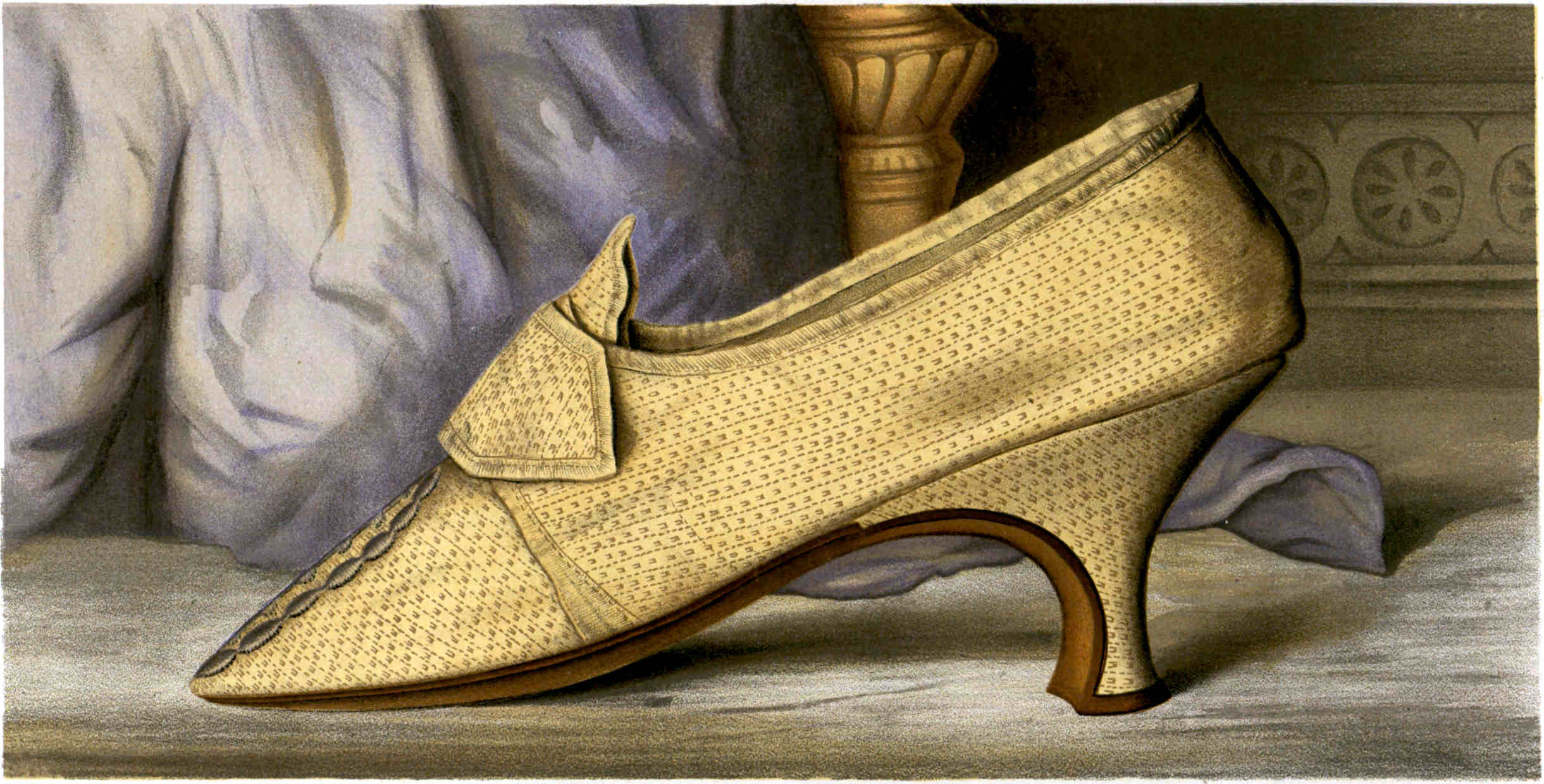 A light tan high-heeled shoe with a pointed toe and a shaped decorative flap on the front, with a stitched design along the toe.
