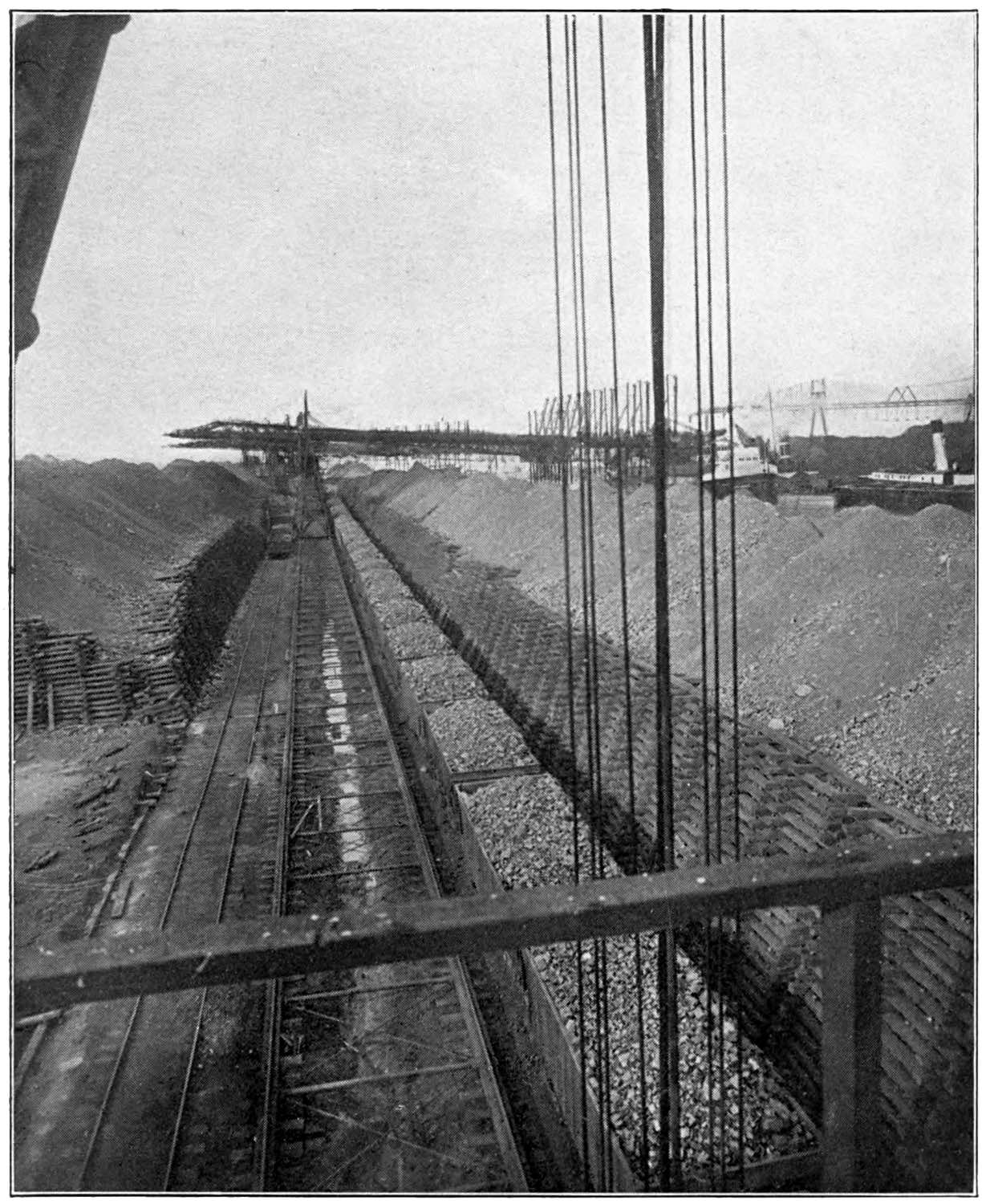 Depicting iron ore in a series of railroad cars.